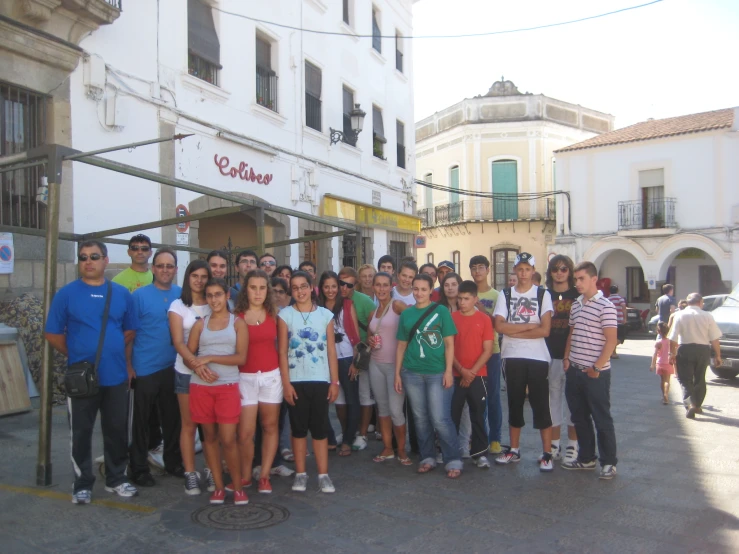 some people are posing for a picture in the street