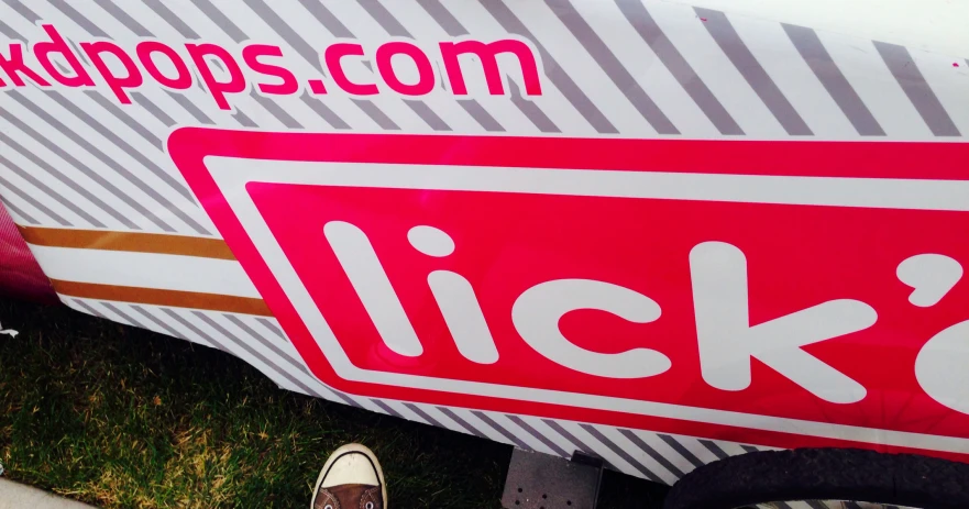 a close - up of a sign on a boat with shoes near the side