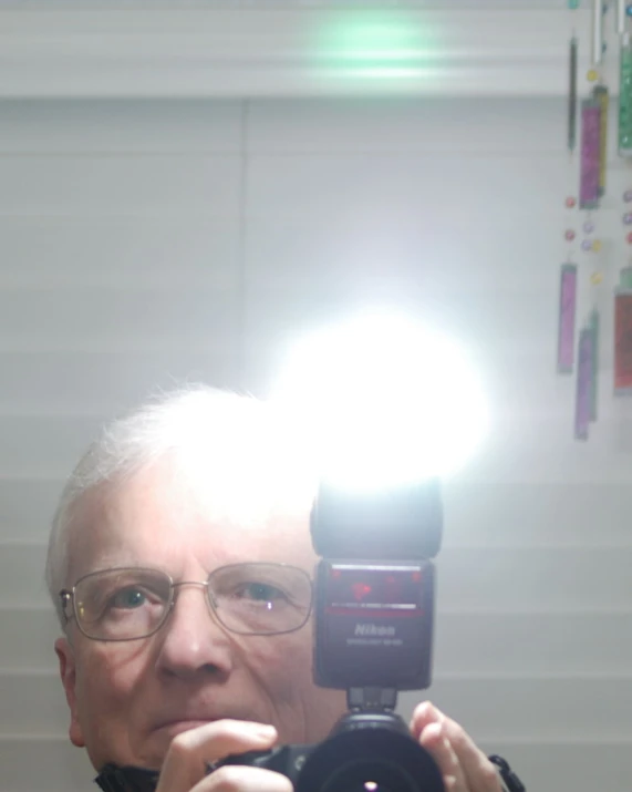 a man holding a camera in front of a mirror