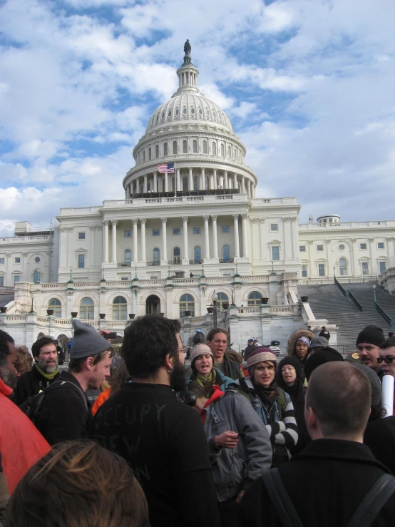 many people outside in front of the capitol building