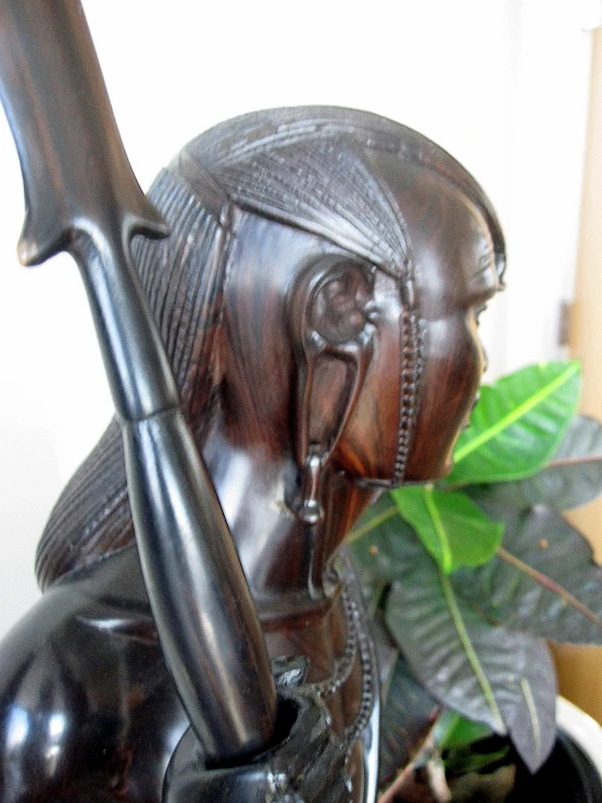 a statue of an indian holding a rifle