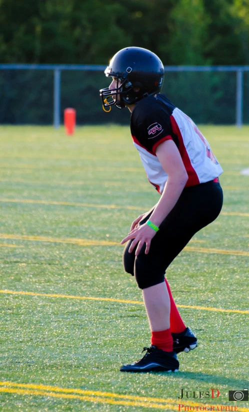 a young man standing on a field playing a game