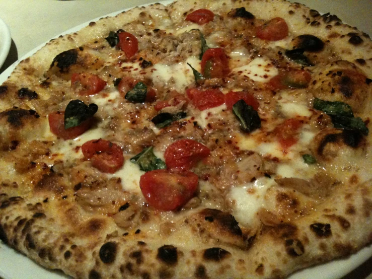 a personal sized pizza on a table ready to be eaten