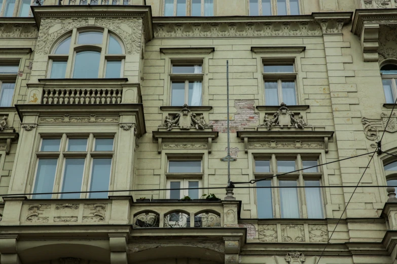 a building with windows and balconies on the second floor