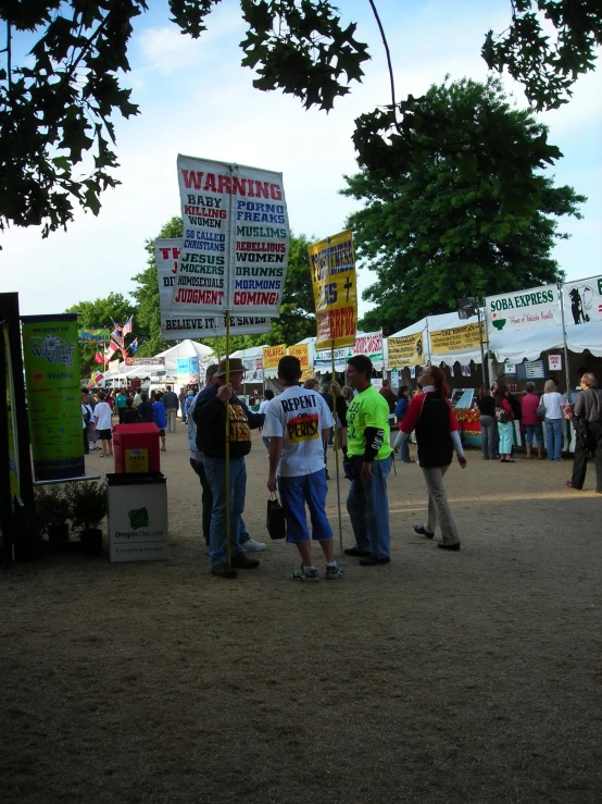 people are standing around at a street fair