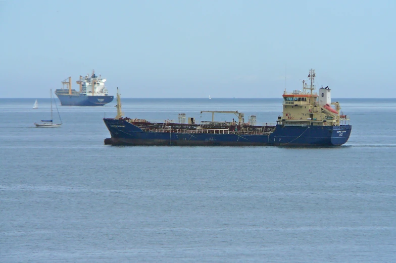 two boats in the ocean one is big and the other is small