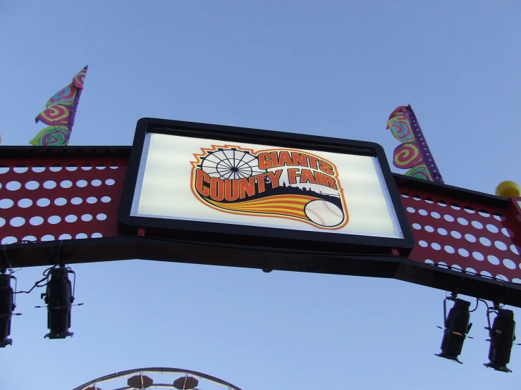 a picture of a carnival sign hanging over a fairgrounds