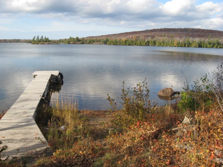 a small pier in front of a large body of water