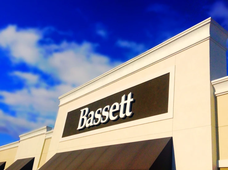 a basetto store with the sign is against a blue sky