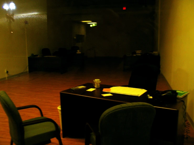 a black table with chairs on it in a dark room
