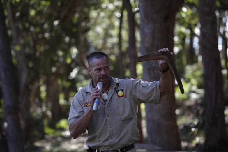 a man in a uniform is holding an axe and a microphone