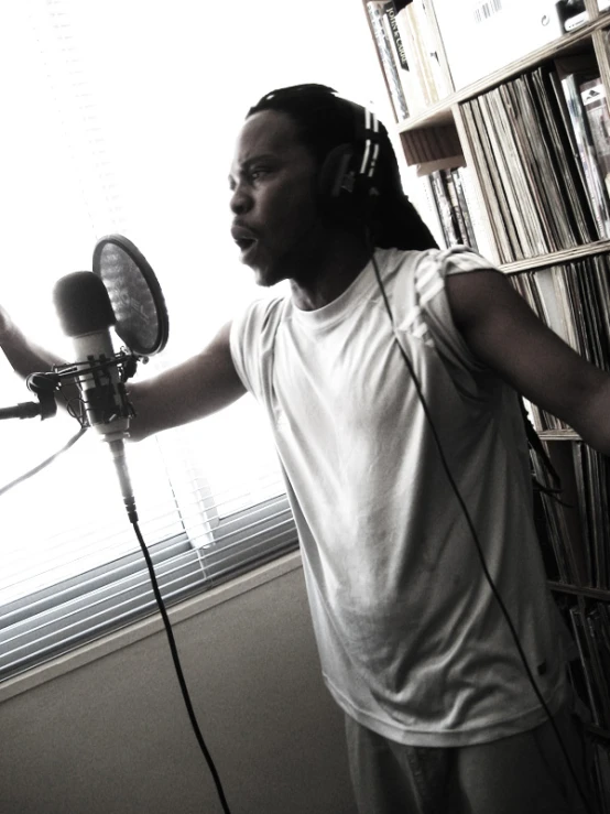 a black - and - white po of a man standing near a cd player