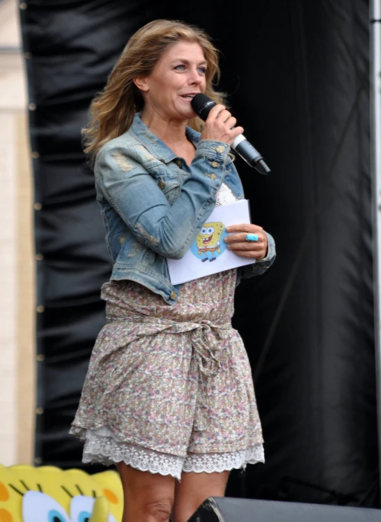 a woman on stage speaking into a microphone