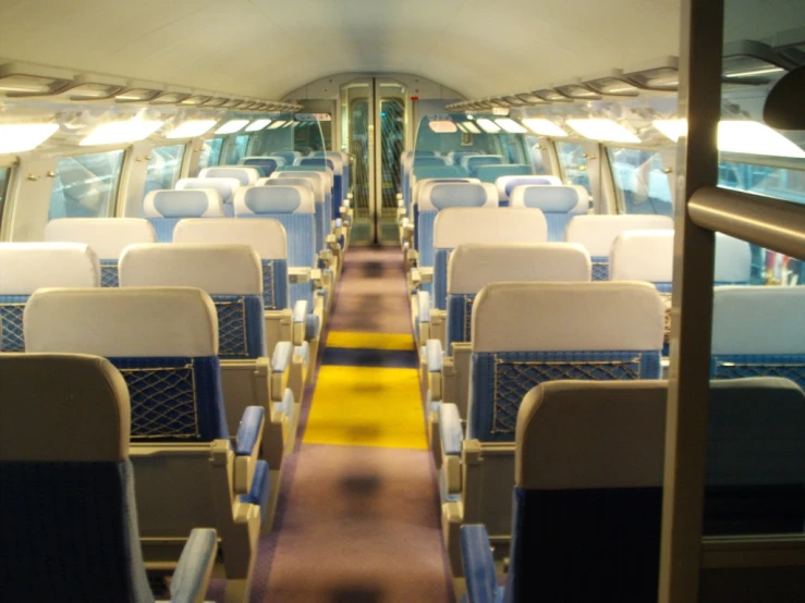 the inside of a passenger train car with lots of seats