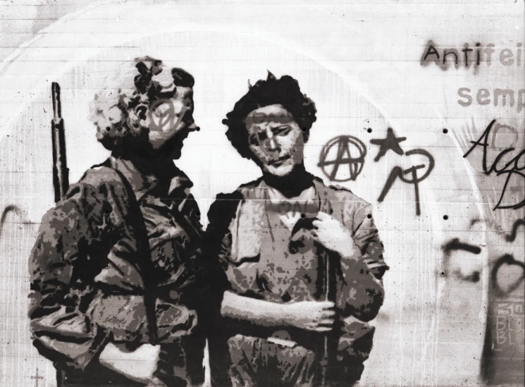 two soldiers talking in front of an art wall