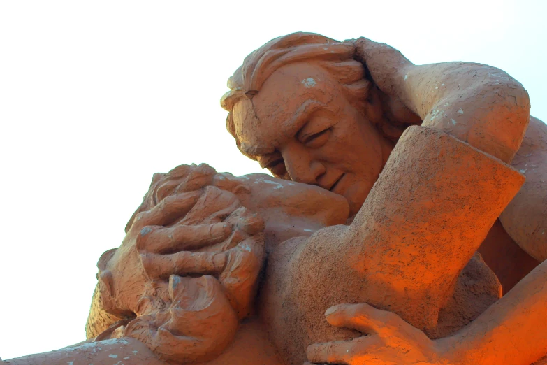 a sand sculpture of an individual emcing someone