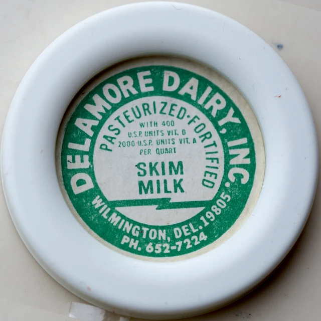 a round green and white drink label on a white background