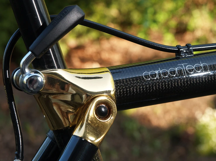 closeup of gold levers on a black and gold colored bike