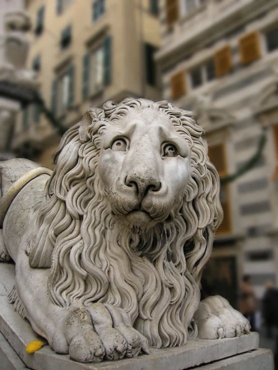 a lion statue on the side of a street