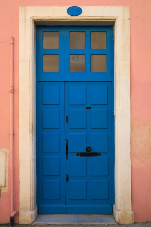 a blue doorway that has a window above it