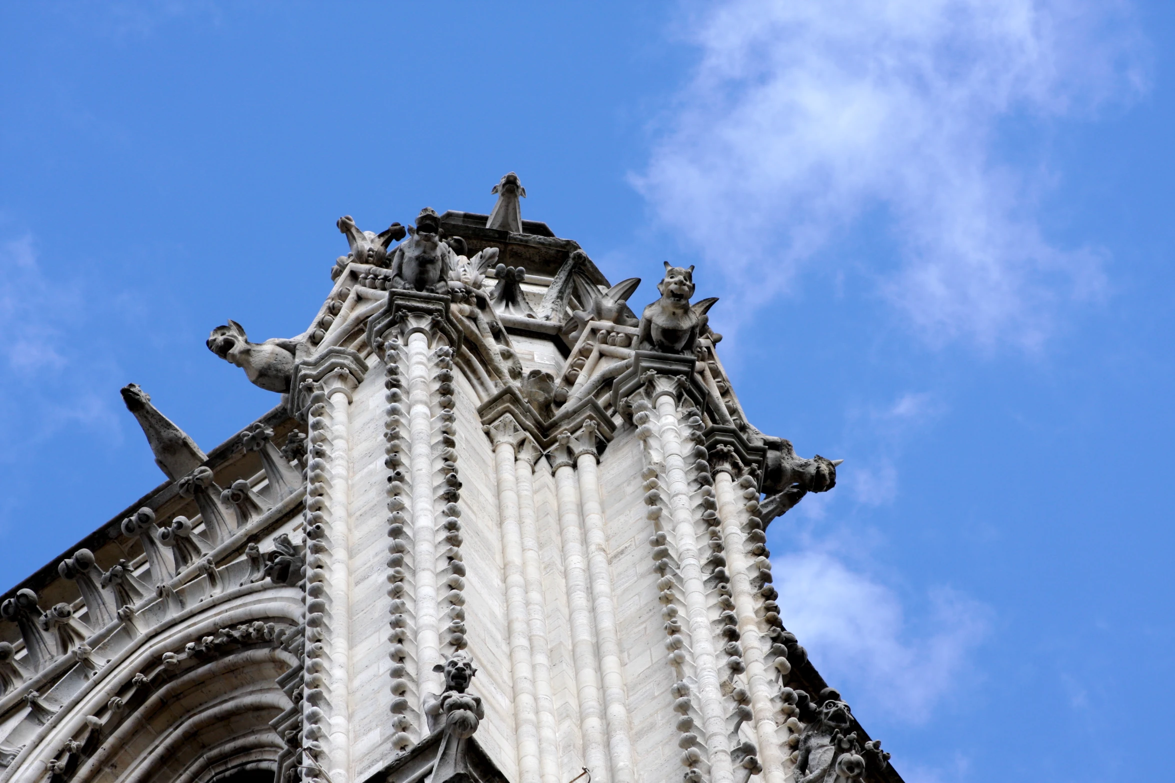 the spire of a church tower is almost obscured by clouds