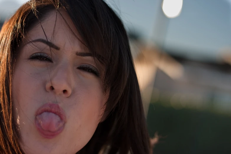 a woman is sticking her tongue out
