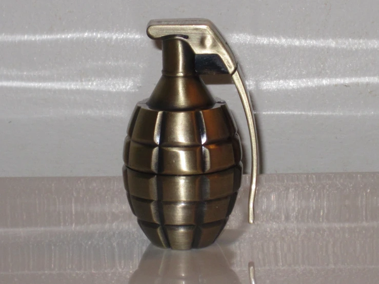 a vase shaped like a bomb in a metallic body