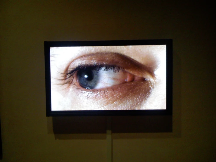 an eye and eyebrows is shown on a television screen