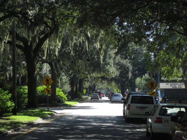 some cars that are driving down the street