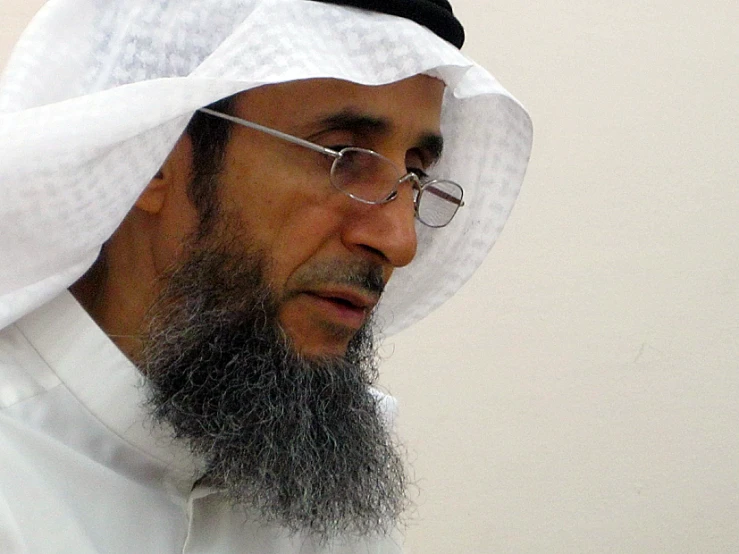 an arabic man with glasses and a beard