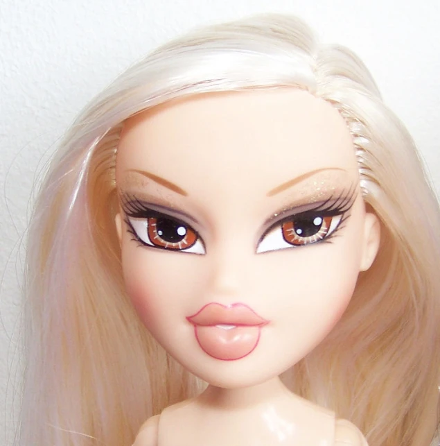 the doll with blonde hair is wearing some fancy hair