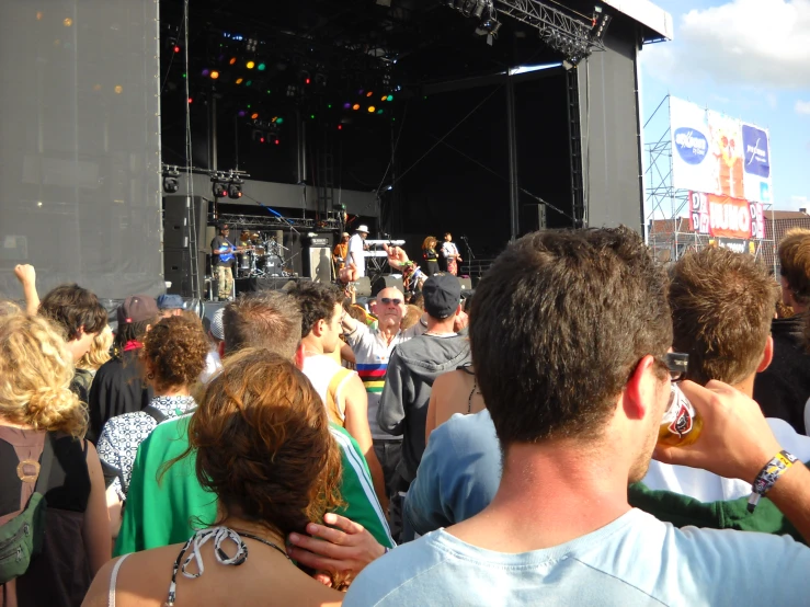people standing in front of an outdoor concert