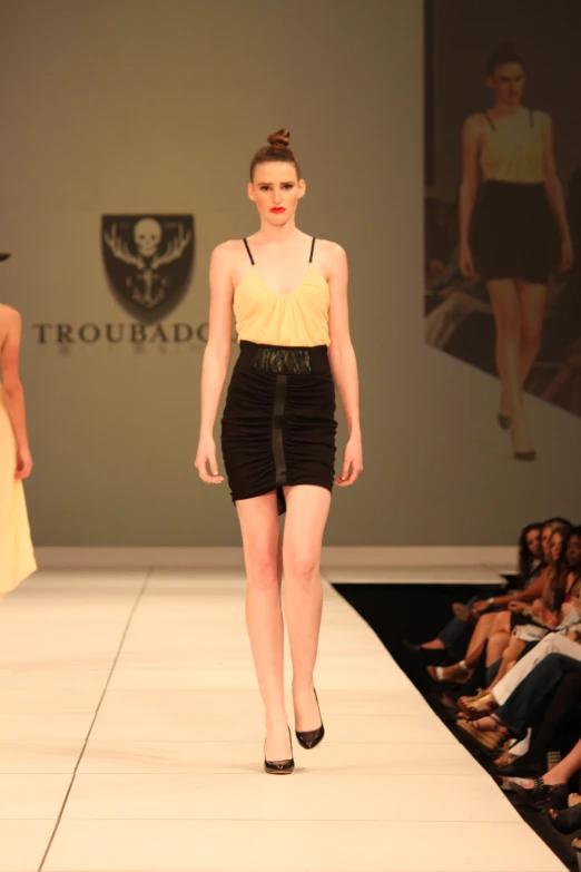 a runway with a girl walking down the runway