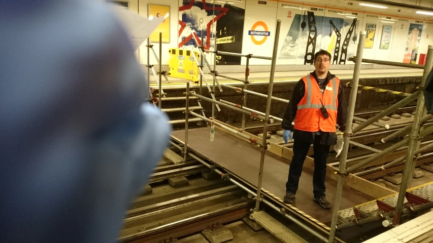 a man is standing on a train platform