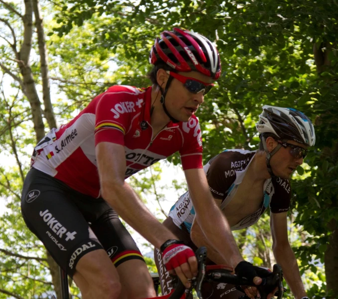 two people wearing bike helmet and bib shorts with knee pads