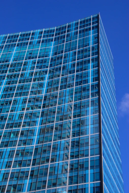 a large tall building with many windows in front of a blue sky