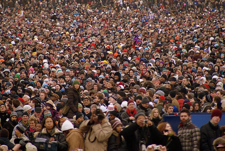 an enormous crowd of people are walking around