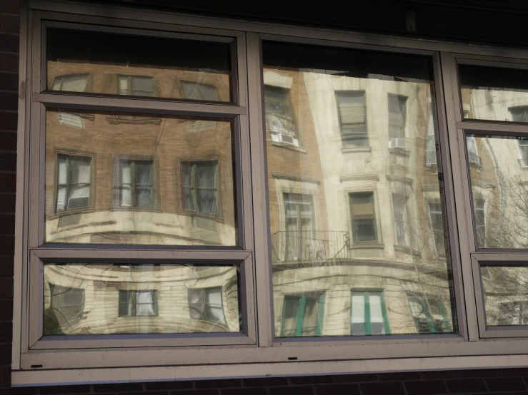 a reflection of a building in a window