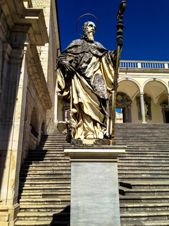 an old statue of the wise man and st peter on the steps