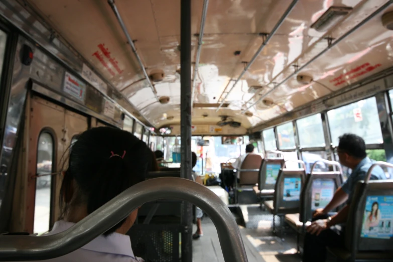 a person sitting on a bus with a view of the inside