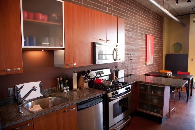 a kitchen with a brick wall and a lot of counter space