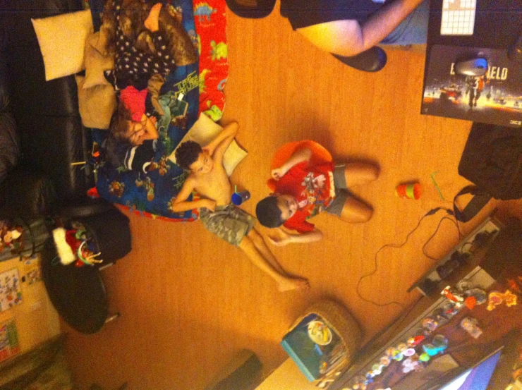 three children and two adults are on the floor of a living room