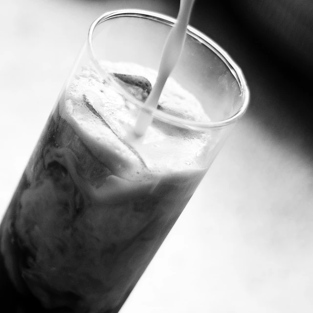 a beverage is seen being poured into a glass