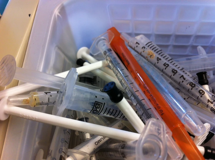 an assortment of medical tubes and sys in a plastic container