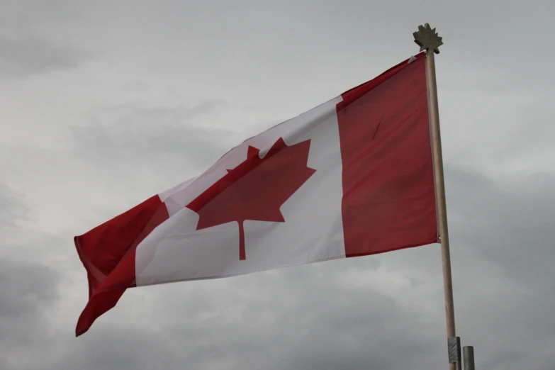 a canada flag is waving in the wind