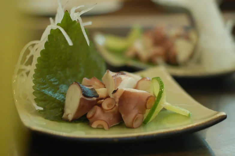 some sort of salad sitting on a small plate