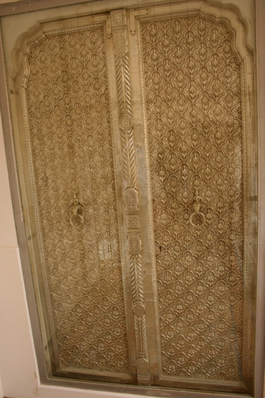 decorative wood paneling on a wall next to a doorway