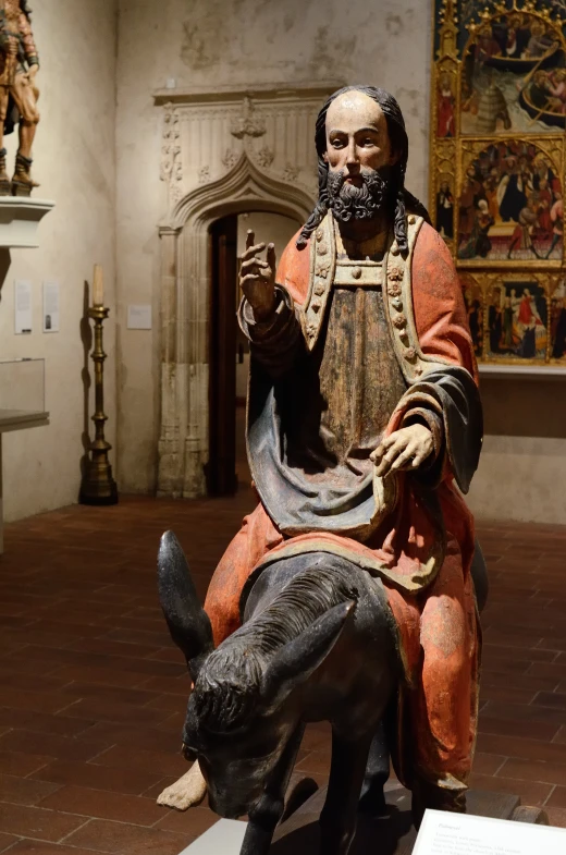 the statue of a man and a donkey on display