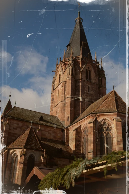 this old cathedral with an arched tower has a green nch on top