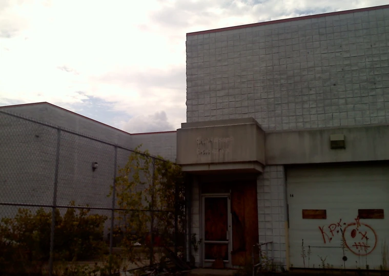 this is a gray house with graffiti on it